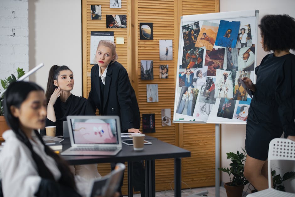 Diverse team of professionals in a collaborative workspace discussing creative ideas with visual references.