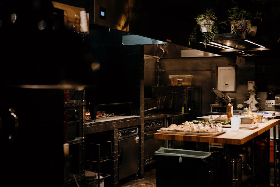 A warm, inviting view of a professional restaurant kitchen with ingredients ready for cooking.