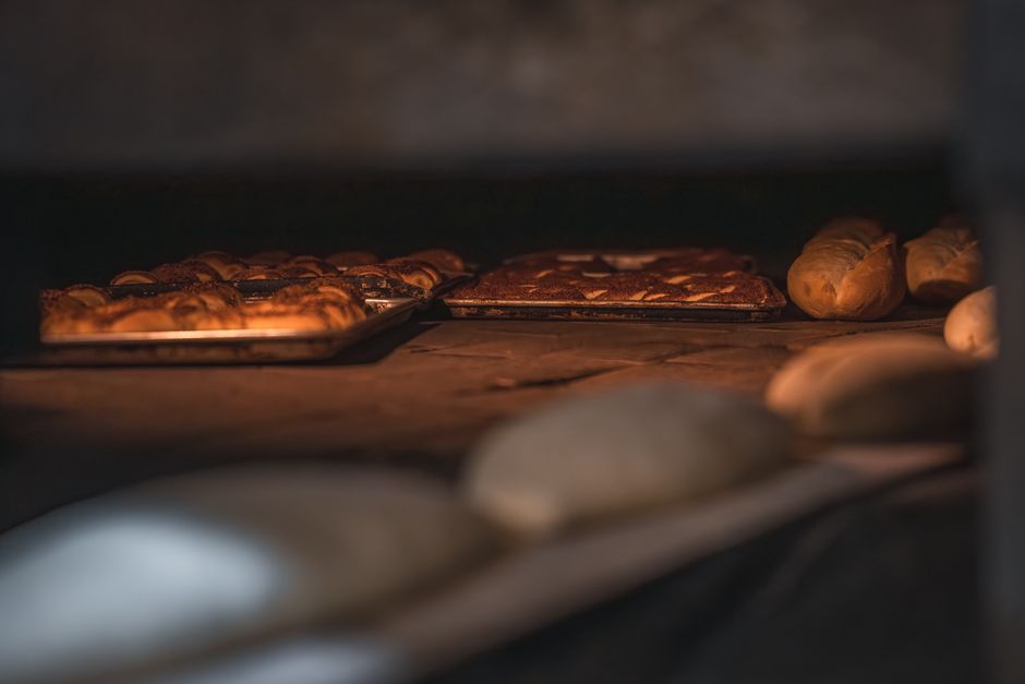 Close-up view of freshly baked bread and pastries in an artisan bakery's oven.