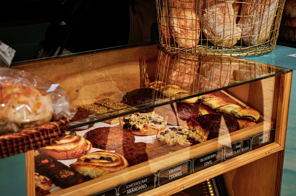 A close-up of assorted pastries and bread in a bakery display in Santiago de Chile.