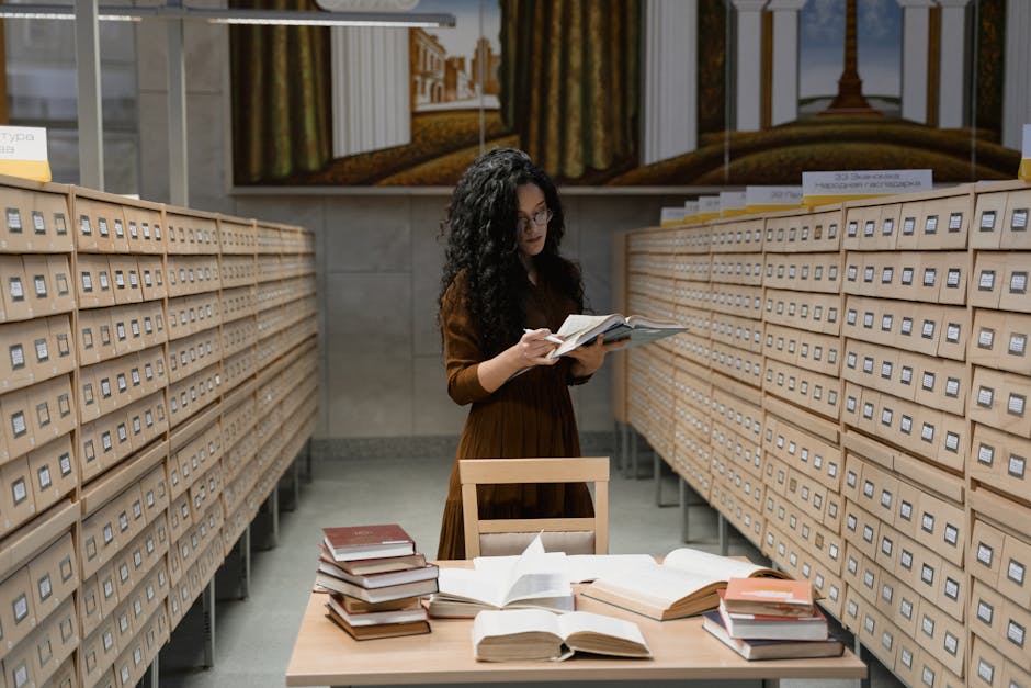 Woman reading in a vintage library with card catalog and books.