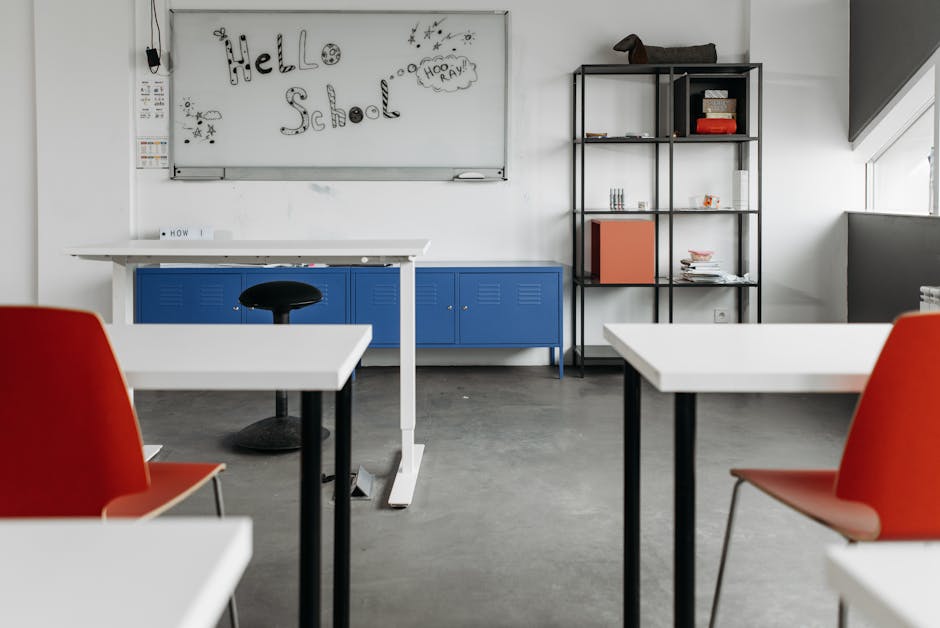 Empty classroom with modern desks, chairs, and whiteboard for educational settings.