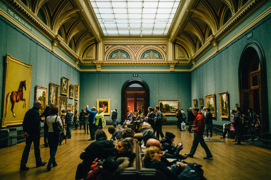 A bustling art gallery with people admiring paintings and architectural details.