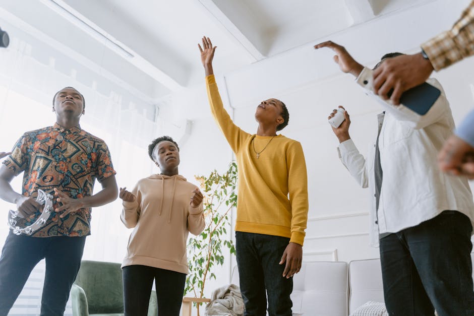 A diverse group of young adults singing passionately indoors, engaged in a choir practice.