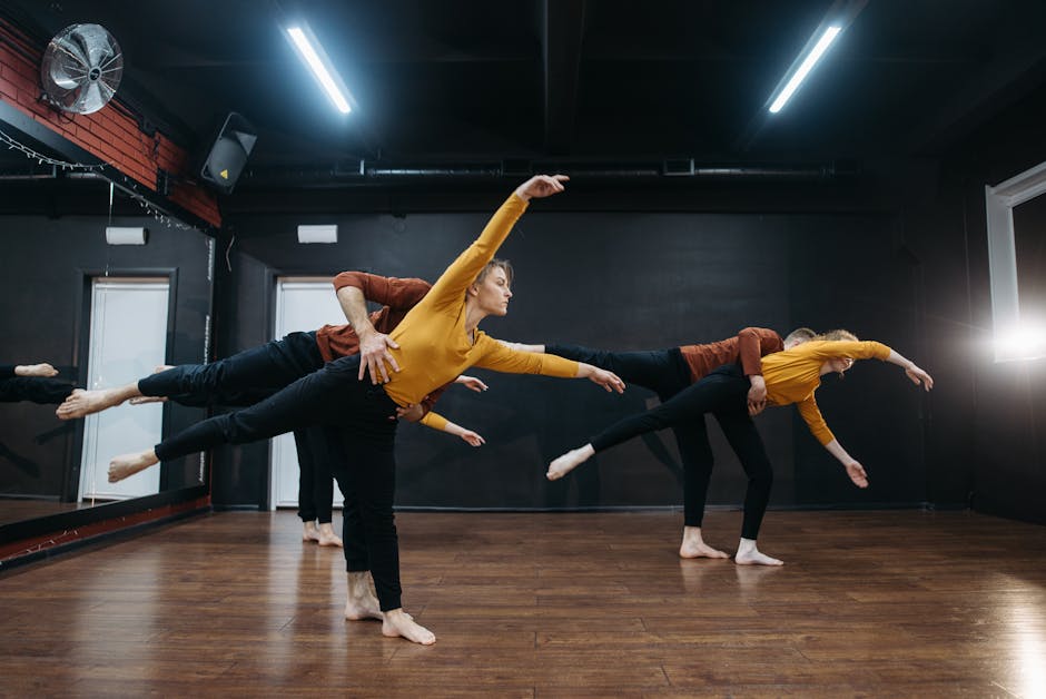 A group of dancers in a studio performing a synchronized routine showcasing flexibility and passion.