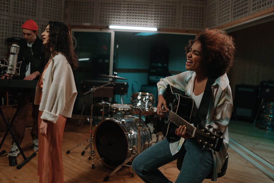 A diverse band passionately rehearsing with instruments in a modern music studio.