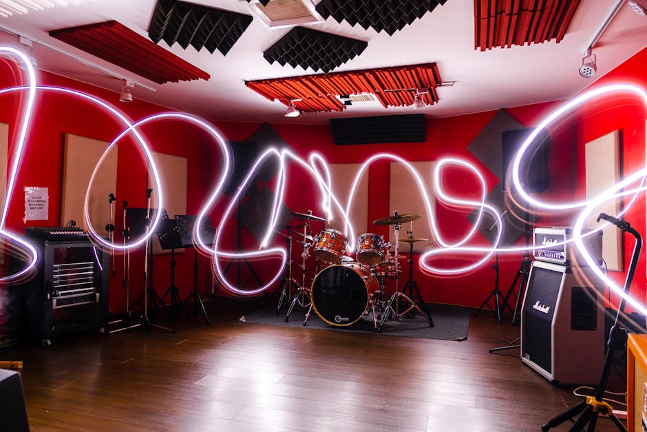 Vibrant music studio featuring drums and artistic light painting, creating a dynamic atmosphere.