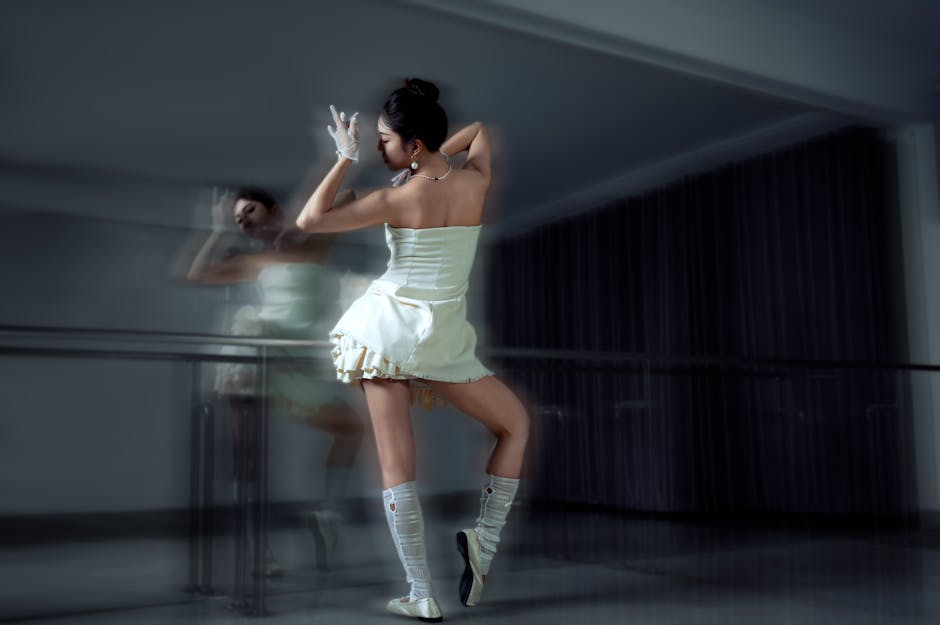 Contemporary dancer striking an elegant pose in a modern studio setting, showcasing artistic expression.