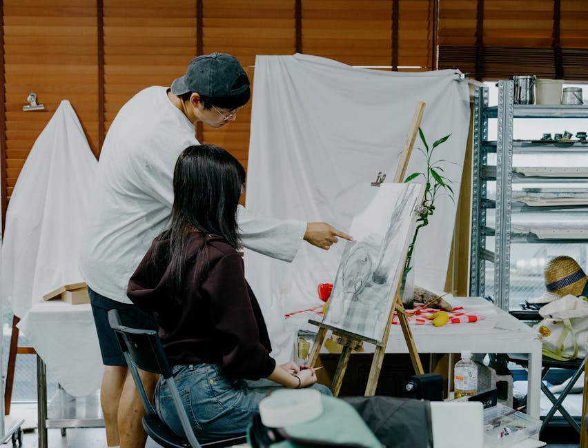 Two students in a Tokyo art studio engaged in a sketching session, focusing on still life subjects.