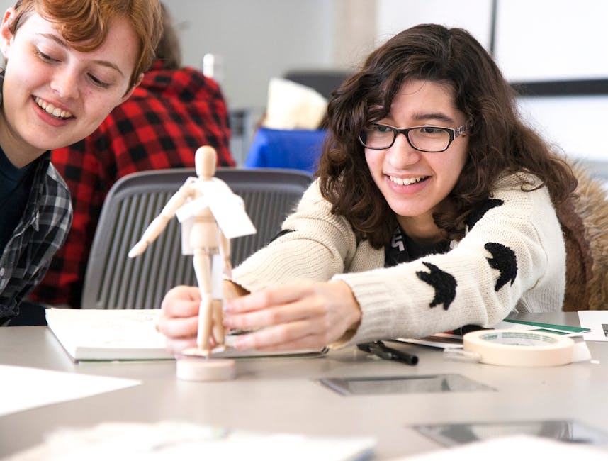 Young adults engaged in a creative design workshop with artistic mannequins, fostering teamwork and creativity.