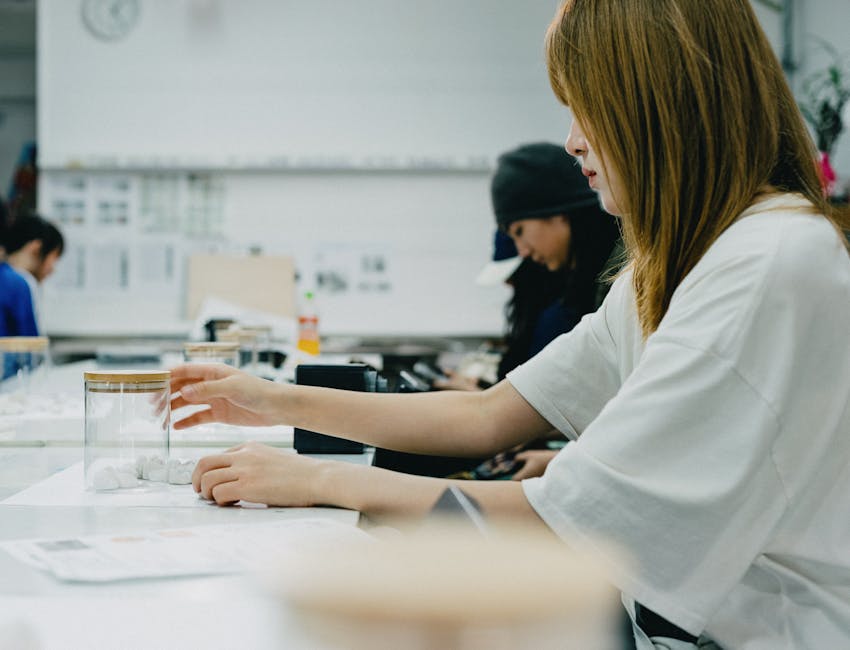 A group of art students in Tokyo focus on a creative workshop, working with drawing materials.